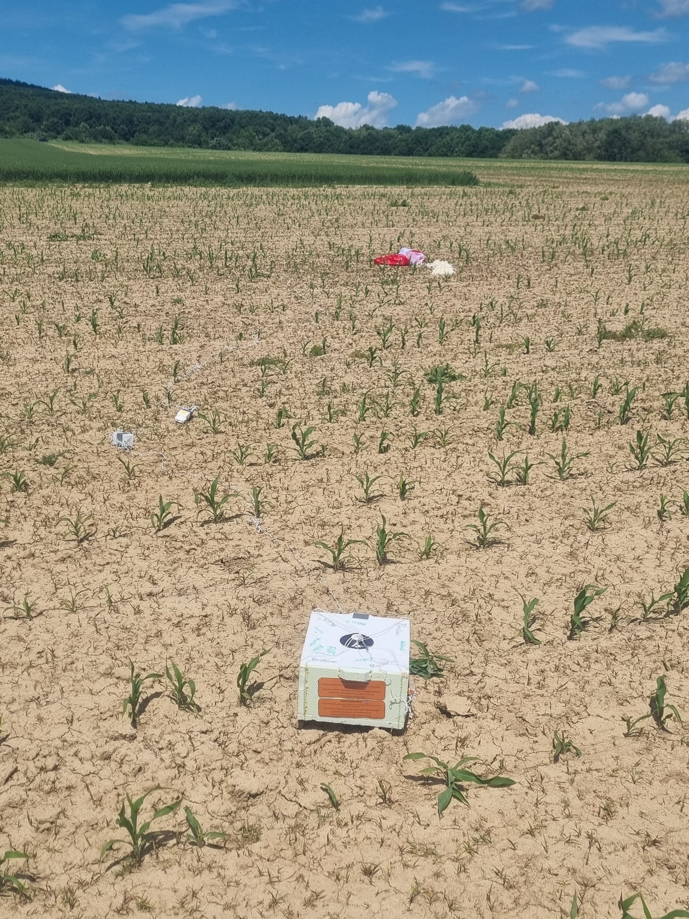 Recovered payload and parachute in a field